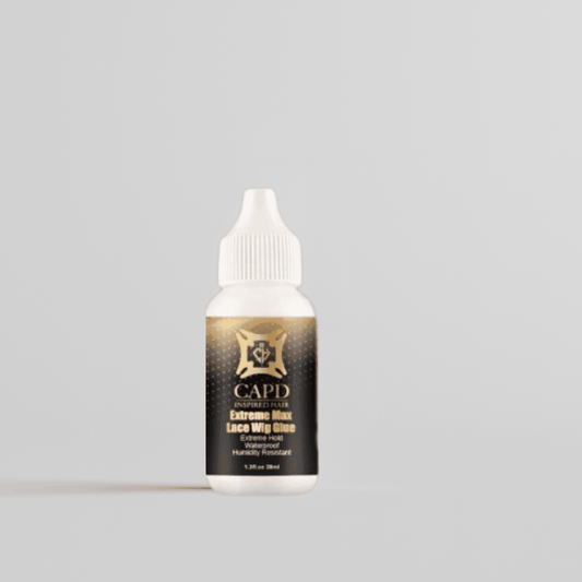 A bottle of PowerHold Lace Adhesive 1.3 oz lace wig glue with a white cap, labeled with the brand CAPD INSPIRED HAIR, against a light background.